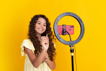Child vlogger making video blog on phone. Blogging weblog and vlog. Teen girl blogger influencer...