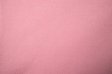 Pink clothes textured background. Close up.