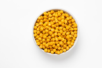 Top view of  Indian crispy, savory snack - roasted  chickpeas, covered with spices on white plate