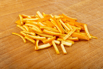 Raw Sliced Orange Peel, Zest on Wood Cutting Board