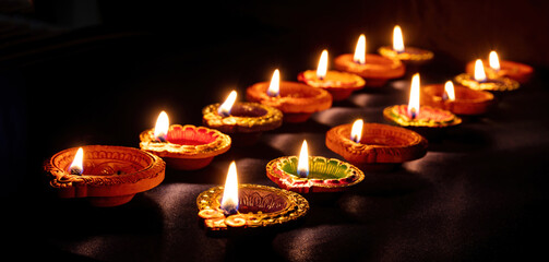 Diwali, Deepavali Hindu festival of lights. Diya lamp lit on black, close up