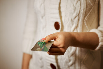 online purchase with a credit card. easy control and money management. woman's hand holding a plastic card