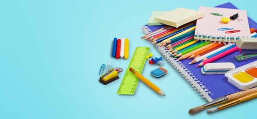 Set of colorful stationery supplies on blue table