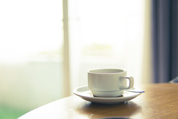 Hot coffee on wooden table close up.