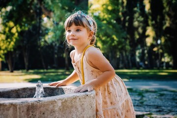 little child with a dress in the sea garden park of varna bapha bulgaria, model shooting 