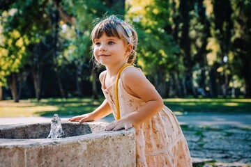 little child with a dress in the sea garden park of varna bapha bulgaria, model shooting 