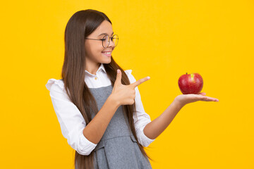 Fresh apple. Teenager girl hold apples on yellow isolated studio background. Child nutrition. Happy girl face, positive and smiling emotions.