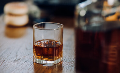a glass of whiskey and wine on the bar.	