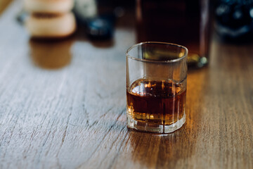 a glass of whiskey and wine on the bar.	