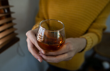 a glass of whiskey on hand, liquidม