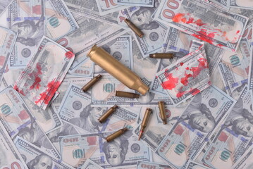 blood money of war. Cartridges with blood in dollar bills
