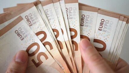 Close up of a woman's hands while counting euro money the value of the european economy. Euro currency exchange. Cash calculation. woman counting euro banknotes. - Powered by Adobe