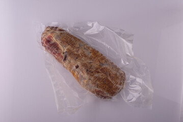 piece of jerky in polyethylene on a white background