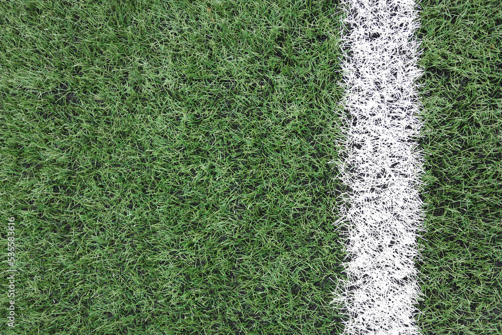 Poster artificial turf with a white stripe close-up. copy space for text