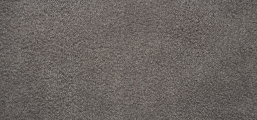 Grey fleece fabric.The texture of the fleece is gray.The background is gray fleece.Fleece fabric surface.