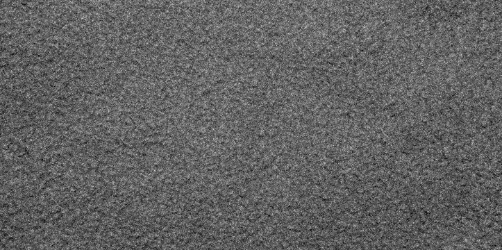 Grey fleece fabric.The texture of the fleece is gray.The background is gray fleece.Fleece fabric surface.