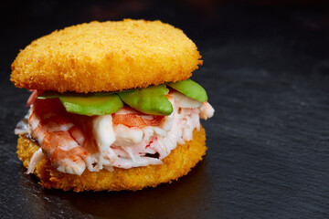 Pan-Asian cuisine concept. Japanese sushi burger made from rice bread, crab meat, avokado and...
