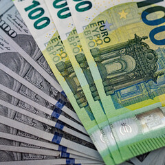 Euro and dollar bills in a common stack. European and US exchange rates - concept.
