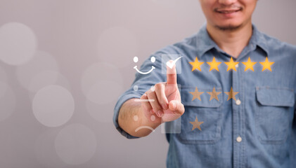 Concept customer satisfaction, service, review, survey, feedback, Businessman touching happy smiley face icon giving satisfaction very impressed service with 5 star rating