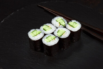 Sushi Maki rolls cucumber. Fresh hosomaki pieces with rice and nori. Close Up of delicious japanese food with sushi roll.
