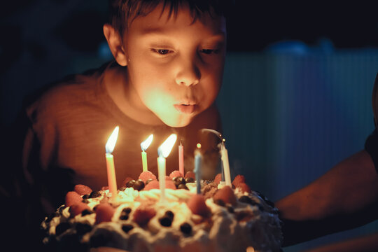 Cute Boy Blowing Birthday Candles