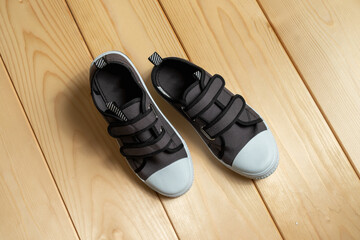 a pair of sneakers on a wooden background.
