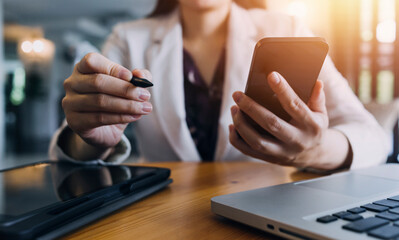 Business partnership coworkers using a tablet to analysis graph company financial budget report and cost work progress and planning for future in office room.
