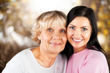 Adult woman with her senior mother in park