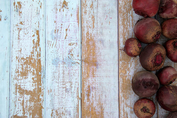 Ripe fresh red beetroot on a wooden background
