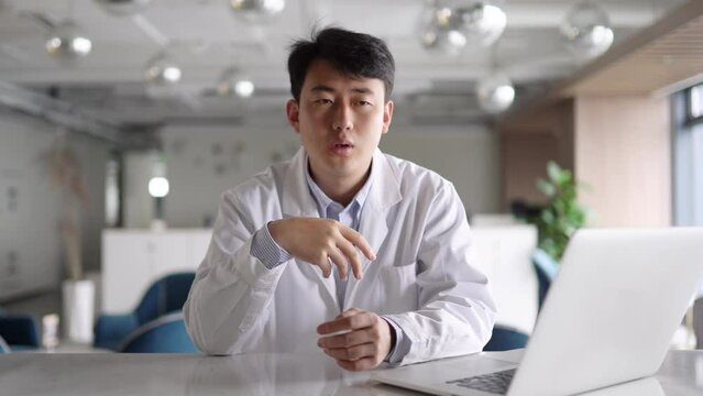 young man doctor works with laptop in office