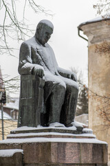  Jozef Montwill bronze statue covered by the snow in Vilnius old town, Polish-Lithuanian social worker, bank owner and philanthropist, vertical - obrazy, fototapety, plakaty