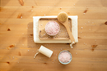Sea salt for the bathroom on the table, natural eco-friendly washcloth and body brush. Free space. 