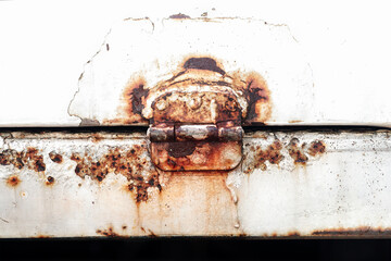 The rusted, corroded steel hinge was discarded. Rust of metals.Corrosive Rust on old iron white. Use as illustration for presentation. Background rusty texture.