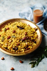 Obraz na płótnie Canvas Tamarind Poha or Puli Aval- Indian breakfast with flattened rice