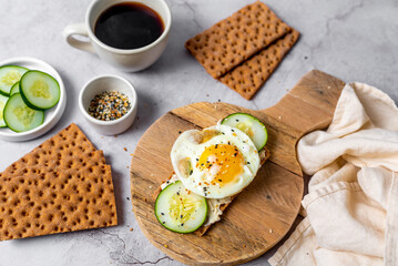 Healthy crispbread breakfast. Whole wheat with cream cheese, cucumbers and egg.  Whole Grain Crispbread for low calory diet.