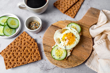 Healthy crispbread breakfast. Whole wheat with cream cheese, cucumbers and egg.  Whole Grain...