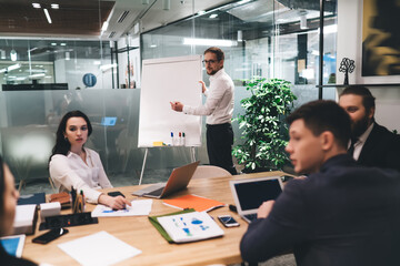 Group of coworkers discussing startup in office