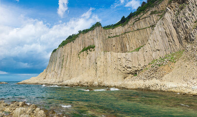 coast of Kunashir Island with columnar basalt cliff, Cape Stolbchaty