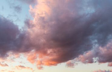 Sunset sky with dark clouds and orange light