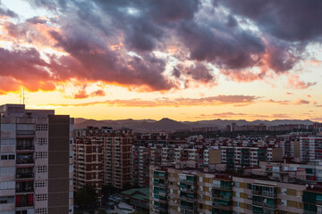 Sunset with dark clouds over the city