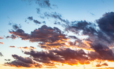 Sunset sky with dark clouds and orange light