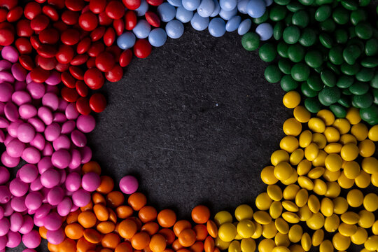 Candy coated chocolate sprinkles in a circle with copy space