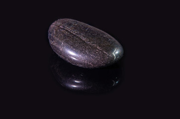 A polished piece of the mineral hematite. Gray stone with whitish veins