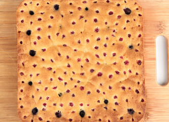 Homemade freshly baked blueberry and redcurrant cake, closed with round holes.