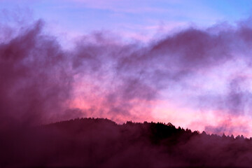 Mountain silhouette at dawn sky with scattered clouds, cold morning in Guatemala, Central America.