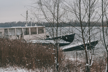 Fototapeta na wymiar An old frozen ship on the banks of the Dnipro River. Kyiv. Ukraine