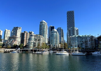 Fototapeta na wymiar Granville Island peninsula and shopping district in Fairview district of Vancouver BC across False Creek from downtown Vancouver under southern end of the Granville Street Bridge 09.2022 Canada