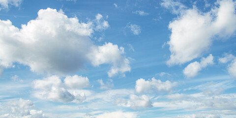 Torn white clouds in a bright blue sky in windy weather
