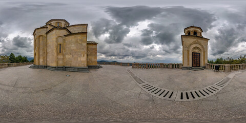 360 hdri panorama near yellow brick orthodox georgian church high in mountains in cloudy day in...