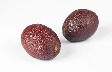 Two red avocados on a white background, Horizontal image